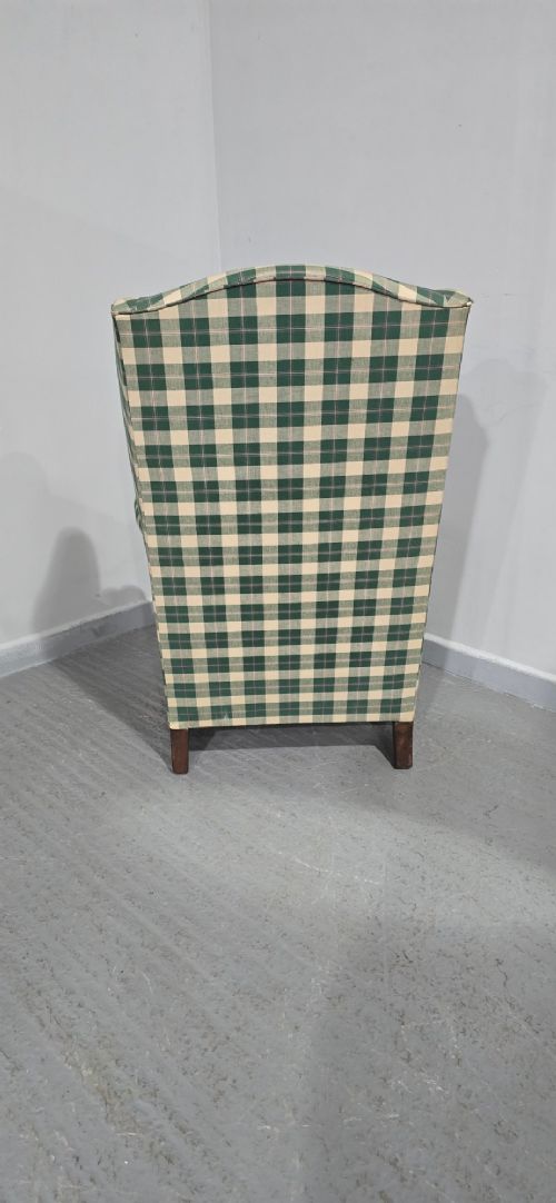 High-backed wingback armchair upholstered in green and cream check fabric with carved oak cabriole front legs. View VII