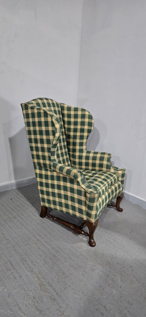 High-backed wingback armchair upholstered in green and cream check fabric with carved oak cabriole front legs. View VIII