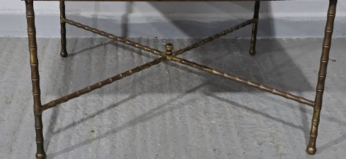 fig 1. A rectangular French coffee table featuring a white veined marble top resting on a gilt brass faux-bamboo frame with an X-shaped stretcher.