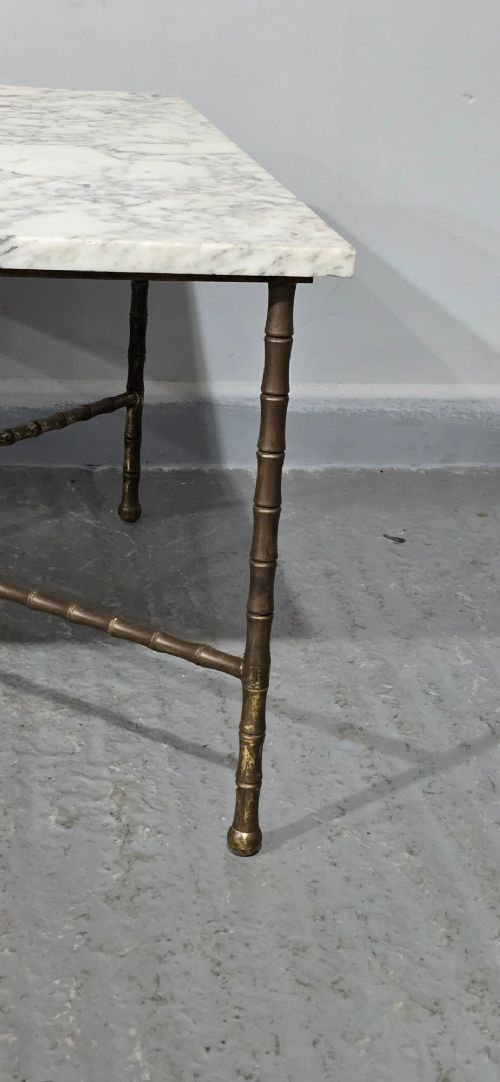 A rectangular French coffee table featuring a white veined marble top resting on a gilt brass faux-bamboo frame with an X-shaped stretcher. View III
