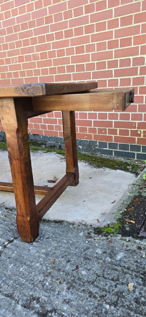 A long solid French oak refectory dining table featuring a plank top and straight legs connected by a low stretcher. View IX