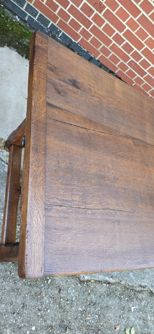 A long solid French oak refectory dining table featuring a plank top and straight legs connected by a low stretcher. View XI