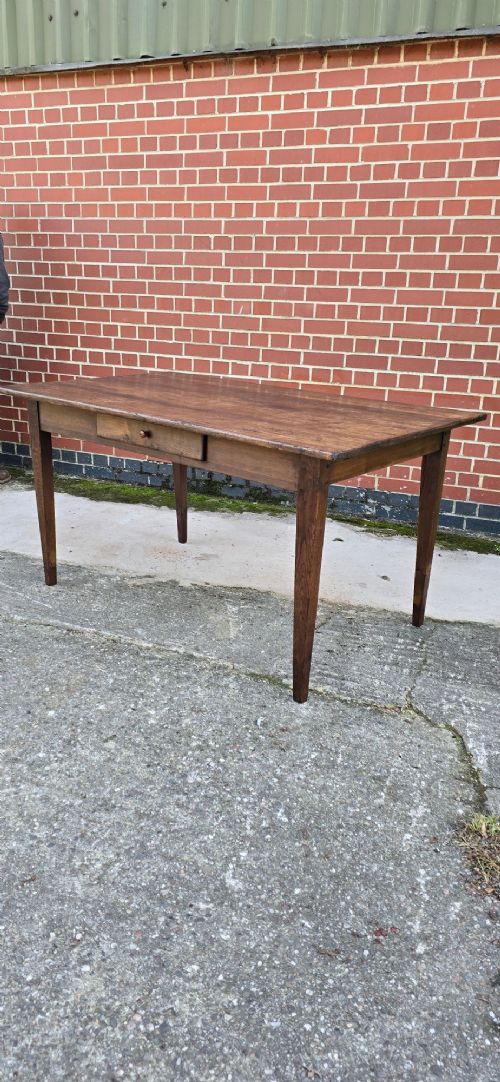 A rectangular rustic oak dining table featuring a frieze drawer with a wooden knob and four square tapered legs. View IV