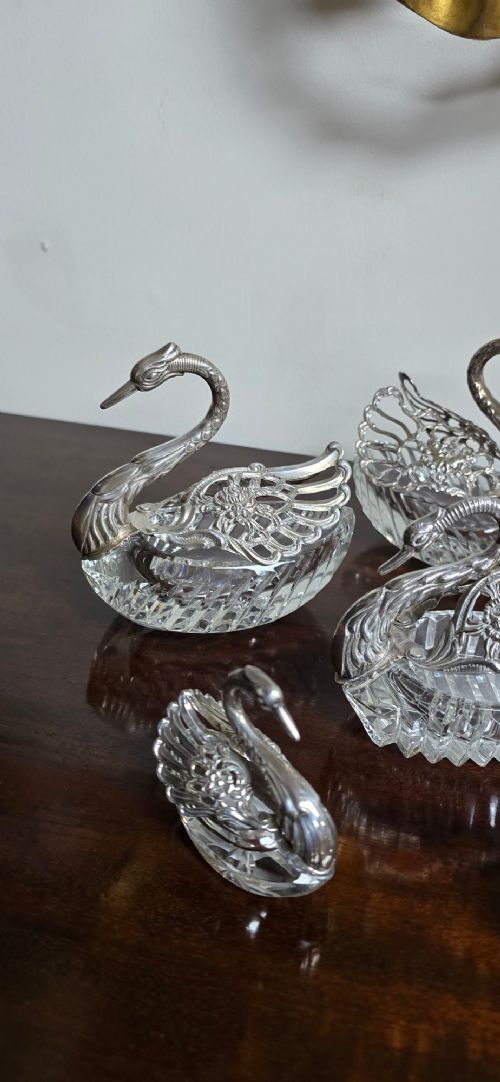 A group of cut glass open salt cellars shaped like swans with silver heads and detailed pierced silver wings. View VII