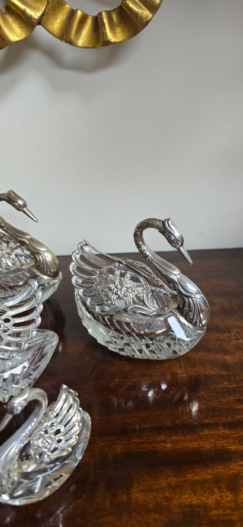 A group of cut glass open salt cellars shaped like swans with silver heads and detailed pierced silver wings. View VIII