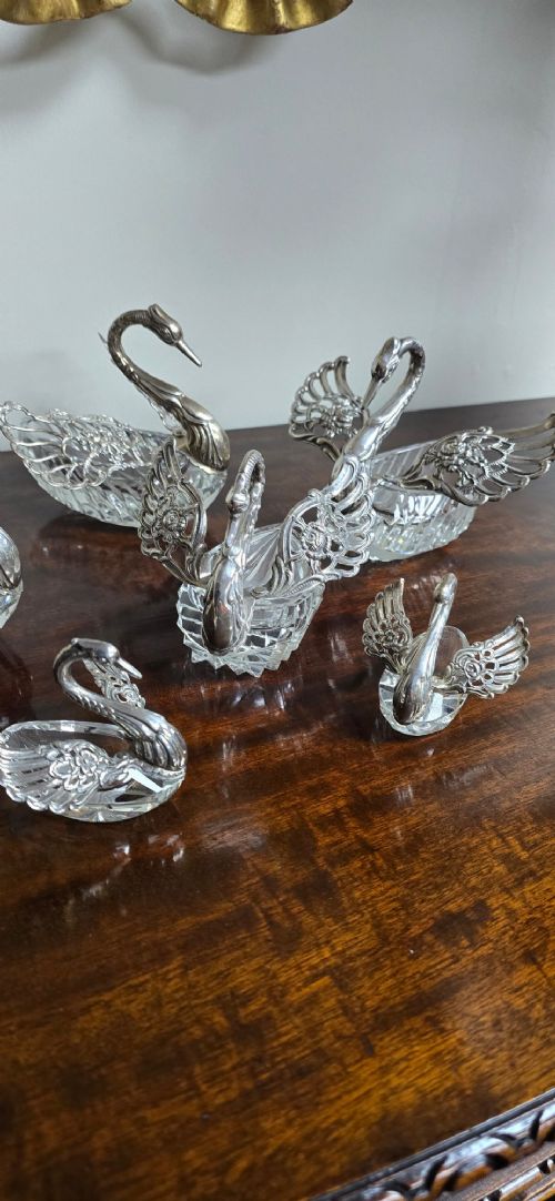 A group of cut glass open salt cellars shaped like swans with silver heads and detailed pierced silver wings. View X