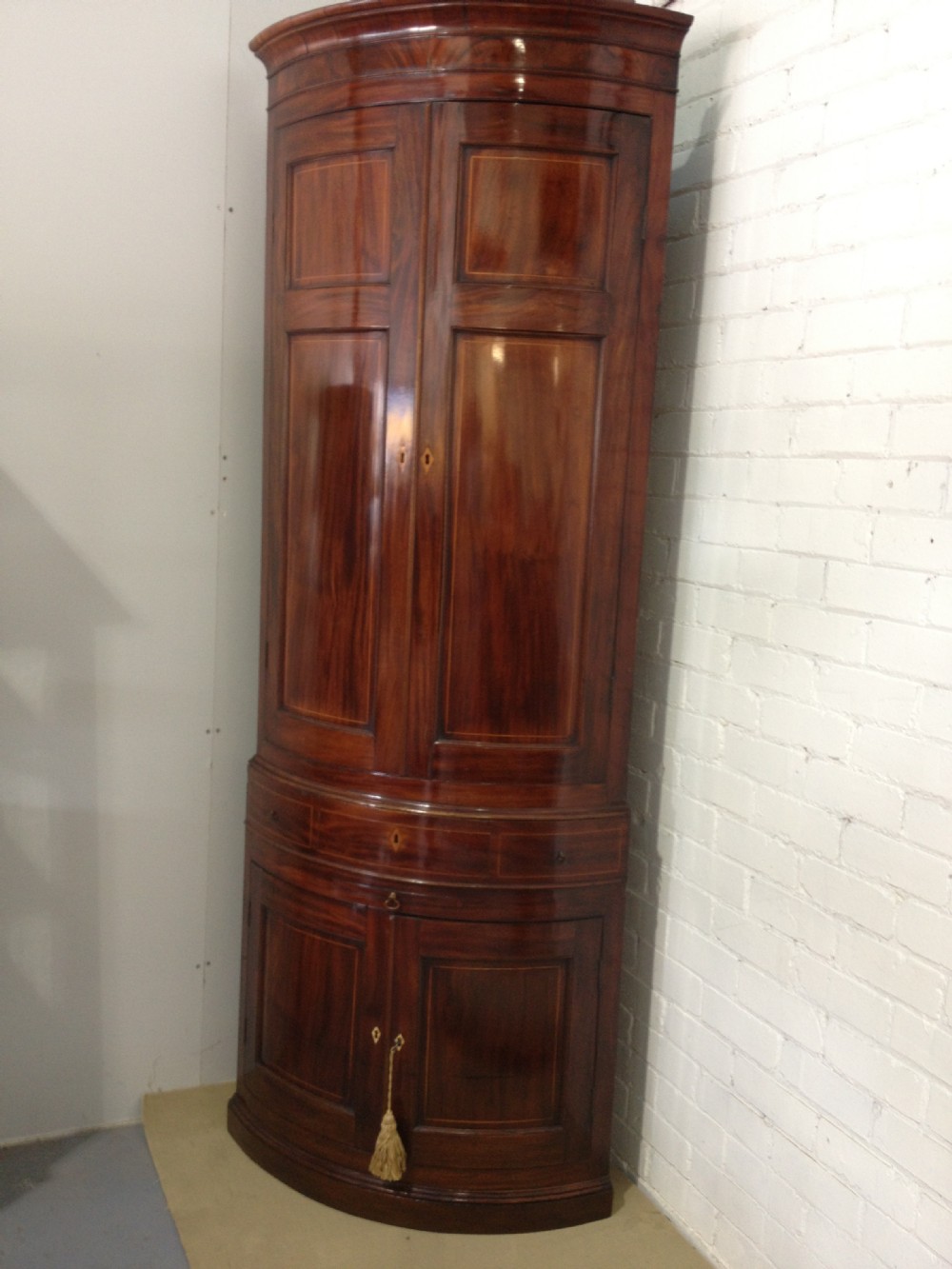 A Stunning Mahogany Bowed Corner Cabinet