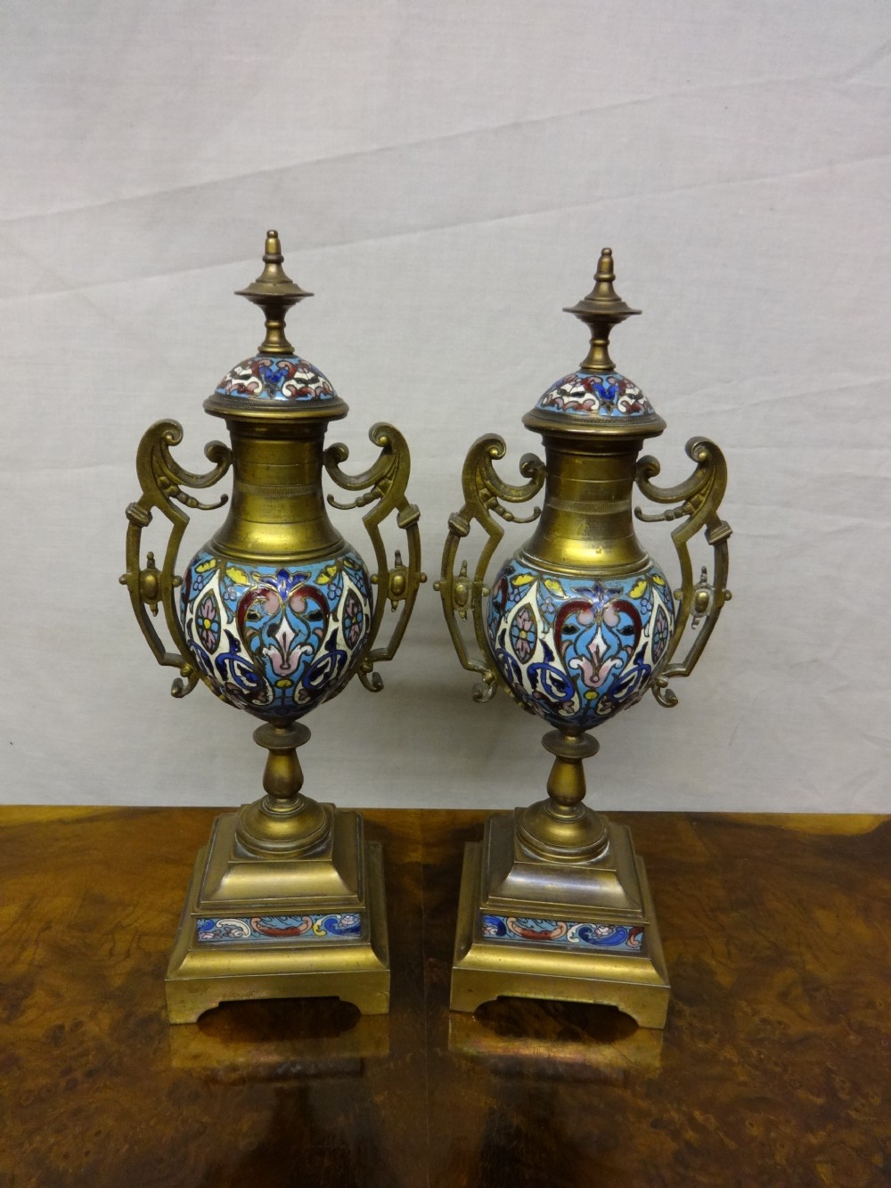 19TH CENTURY GILT METAL AND CHAMPLEVE ENAMELLED  PEDESTAL URNS