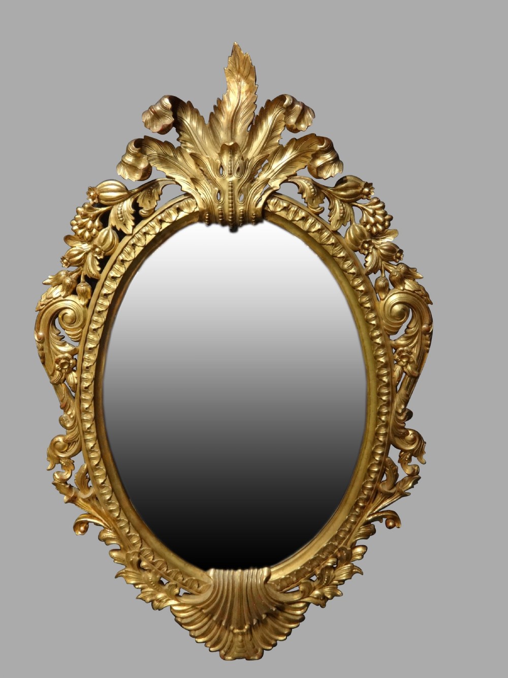 Fine and Large Carved Oval Giltwood Mirror