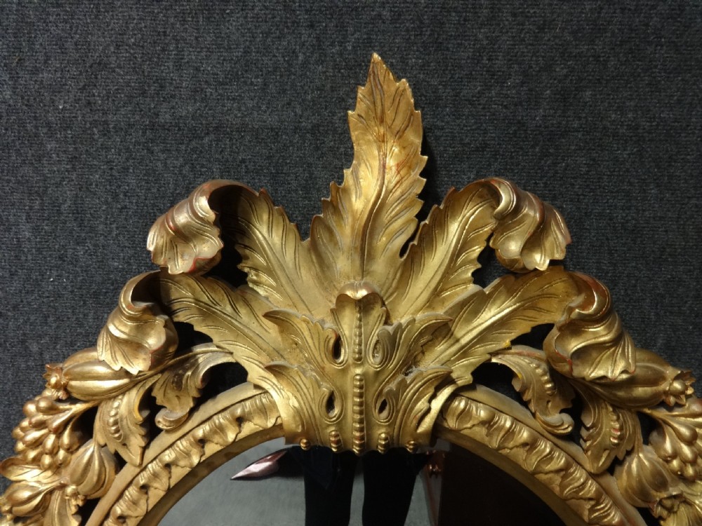 Fine and Large Carved Oval Giltwood Mirror View II