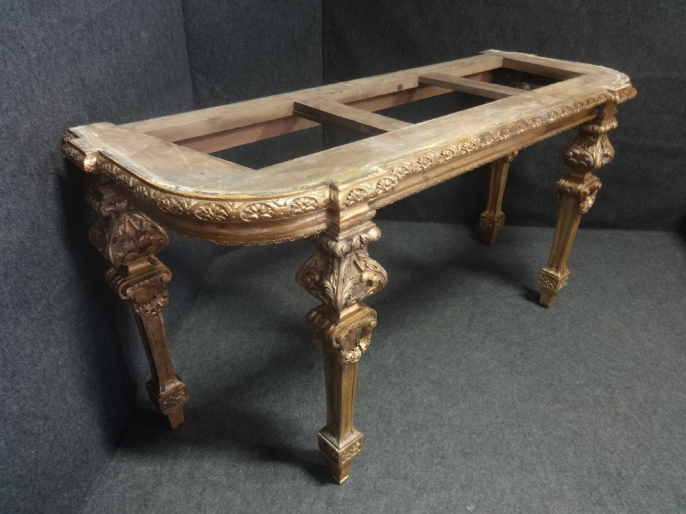 A Regency period giltwood console table featuring carved scroll support legs and a white marble top. View VIII