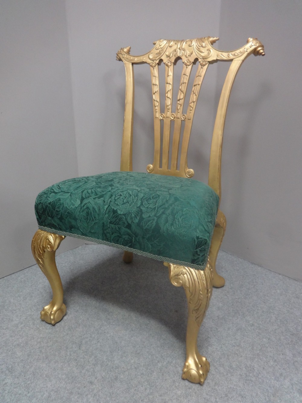 A Georgian giltwood side chair featuring carved cabriole legs with claw and ball feet, an ornate pierced splat back, and green patterned upholstery. View II