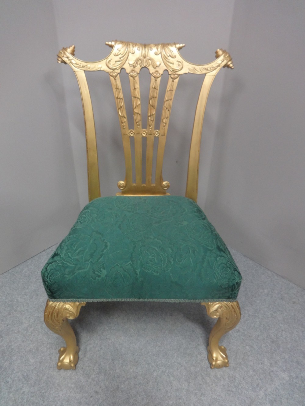 A Georgian giltwood side chair featuring carved cabriole legs with claw and ball feet, an ornate pierced splat back, and green patterned upholstery. View III