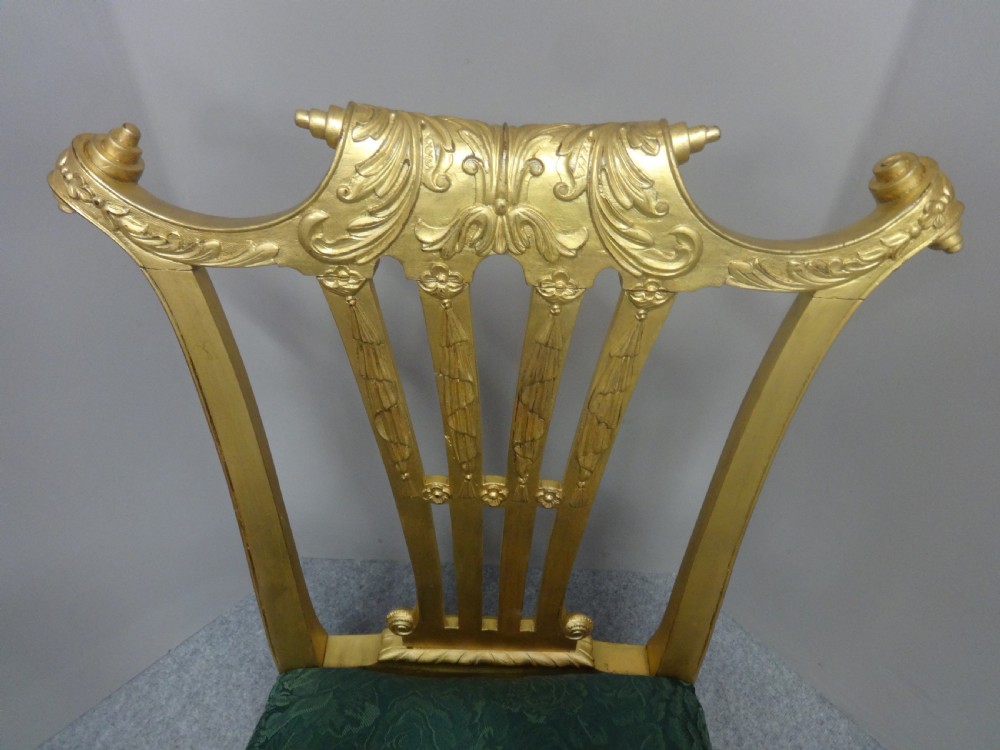 A Georgian giltwood side chair featuring carved cabriole legs with claw and ball feet, an ornate pierced splat back, and green patterned upholstery. View V
