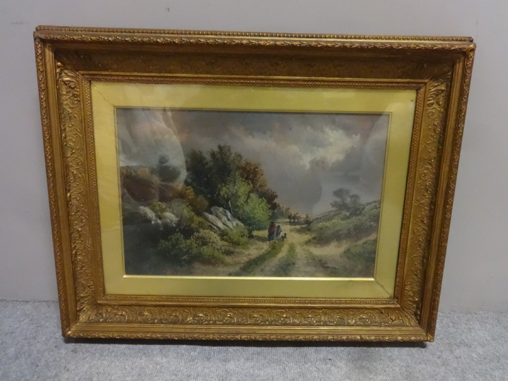 A Victorian landscape oil painting depicting figures on a dirt path through a rural countryside scene, framed in an ornate gilded frame. View V