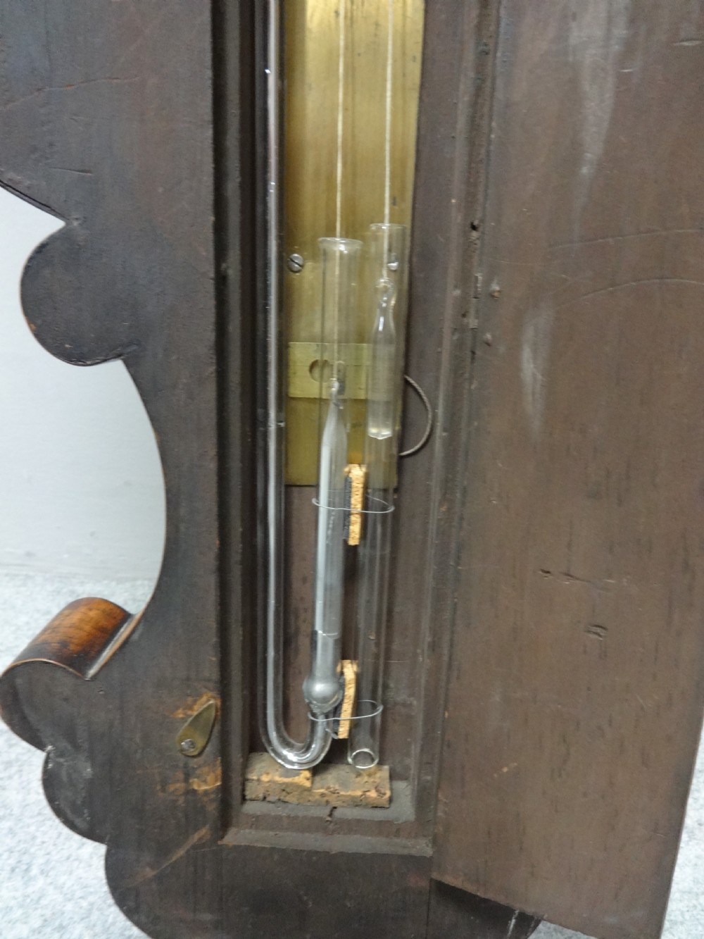 A nineteenth-century rosewood wheel mercury barometer with a brass-trimmed silvered dial and an integrated thermometer tube. View VIII
