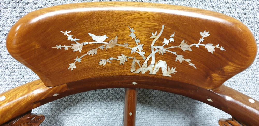 A pair of warm brown hardwood Chinese corner chairs featuring intricate mother-of-pearl floral inlays and carved pierced back splats. View XII