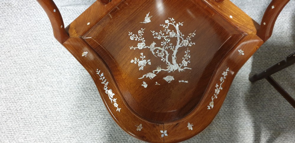 A pair of warm brown hardwood Chinese corner chairs featuring intricate mother-of-pearl floral inlays and carved pierced back splats. View XIII