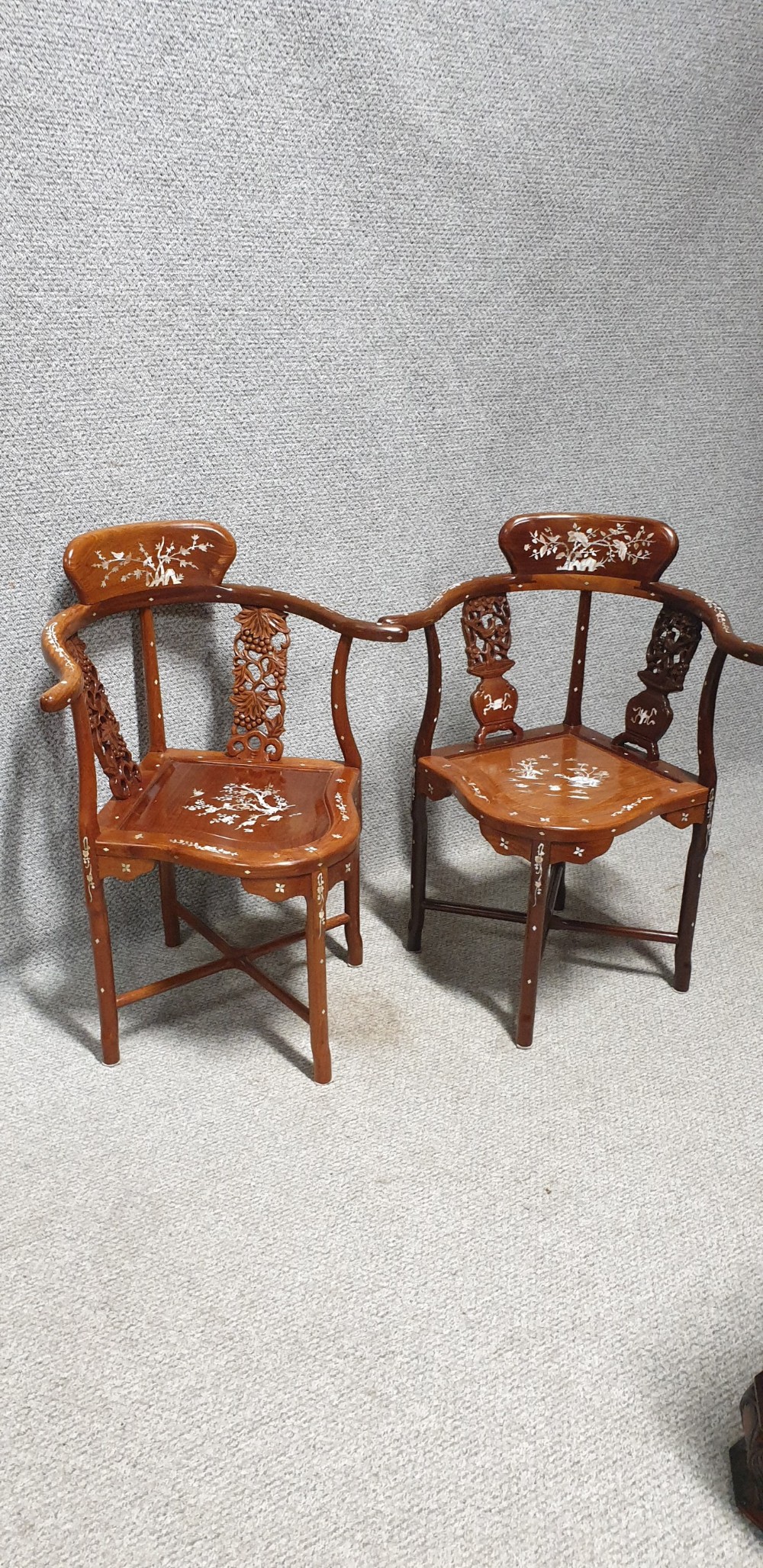 A pair of warm brown hardwood Chinese corner chairs featuring intricate mother-of-pearl floral inlays and carved pierced back splats. View XIV