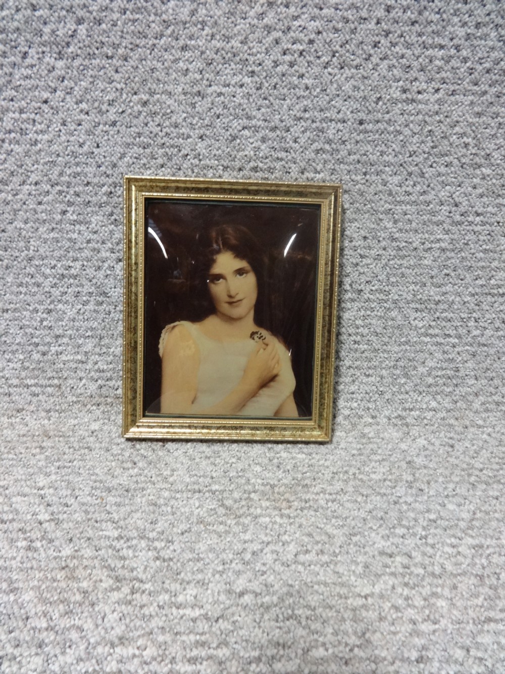 A 19th-century Victorian chrystoleum depicting a female portrait in a light dress, set within a rectangular gilt wood frame.