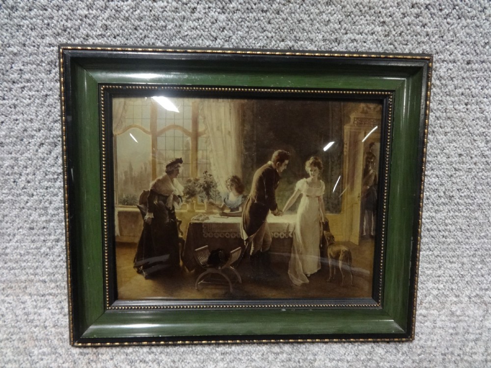 A 19th-century framed chrystoleum print depicting a courtship scene inside a Regency-style interior, set within a dark green and gilt beaded wooden frame.