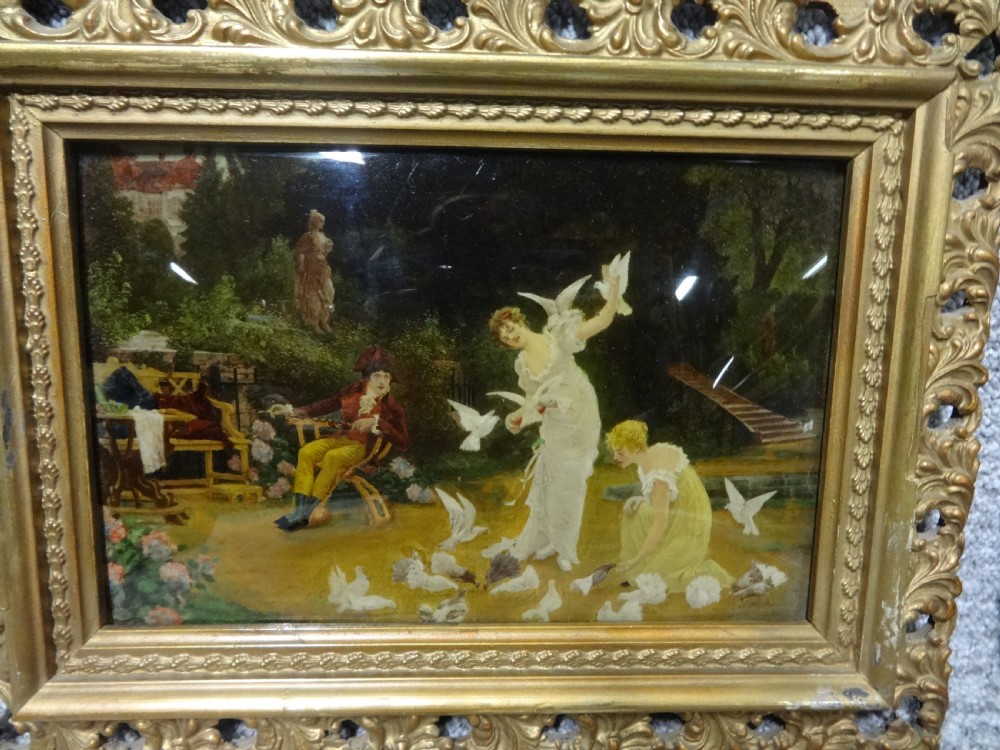 A pair of late 19th-century chrystoleum glass prints depicting romantic garden scenes inside ornate gold gilt frames. View II
