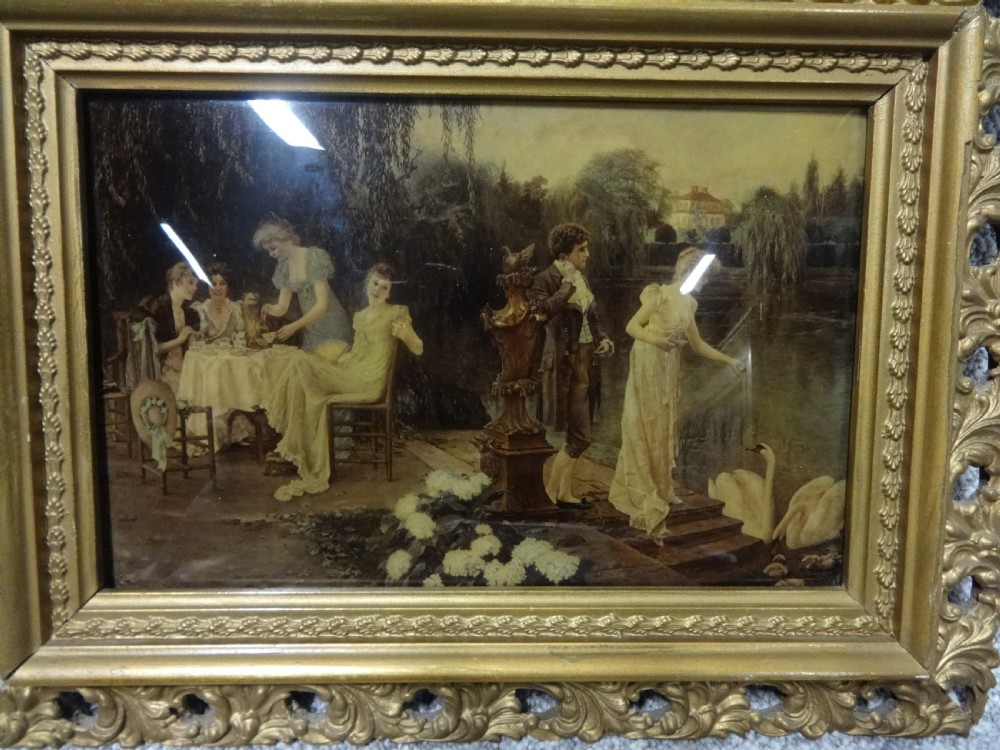 A pair of late 19th-century chrystoleum glass prints depicting romantic garden scenes inside ornate gold gilt frames. View III