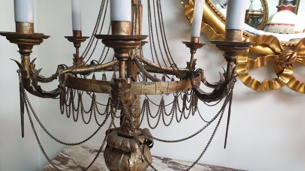A pair of tall giltwood and metal eight-branch French candelabra table lamps featuring hanging wire swags and a tented canopy top. View IV