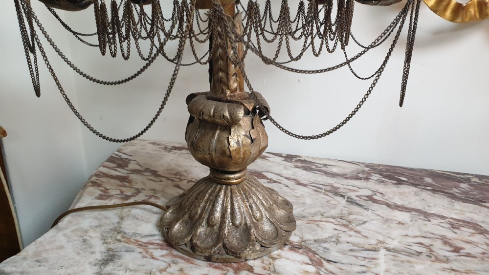 A pair of tall giltwood and metal eight-branch French candelabra table lamps featuring hanging wire swags and a tented canopy top. View V