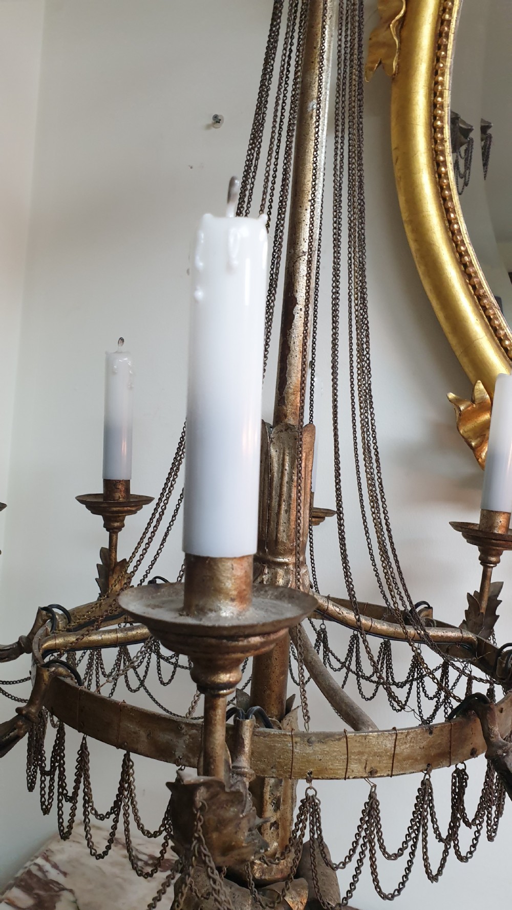 A pair of tall giltwood and metal eight-branch French candelabra table lamps featuring hanging wire swags and a tented canopy top. View VI
