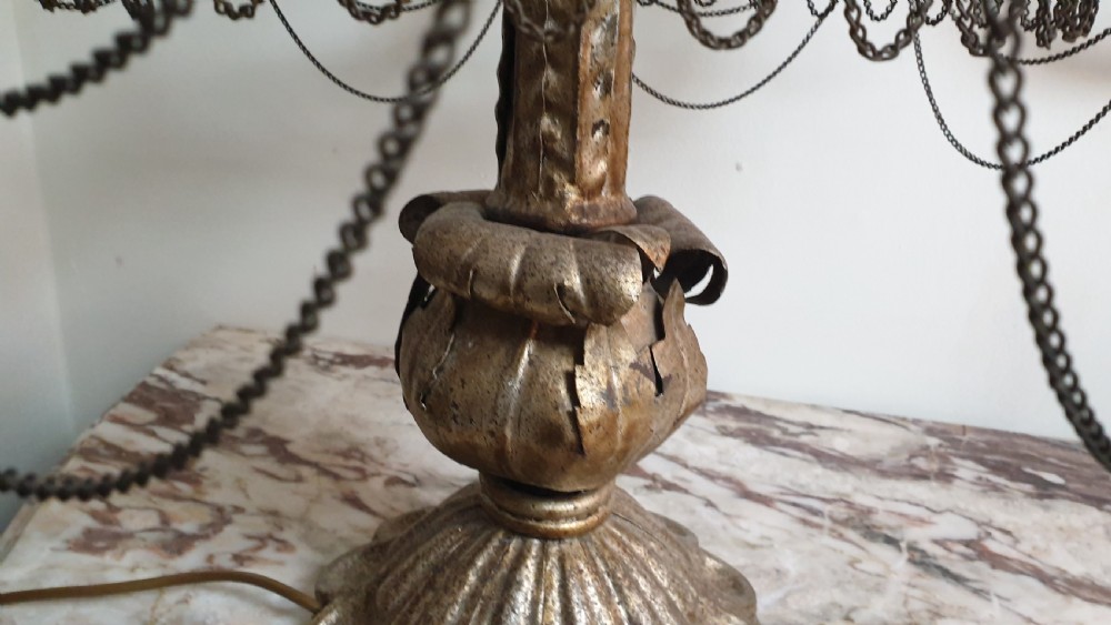 A pair of tall giltwood and metal eight-branch French candelabra table lamps featuring hanging wire swags and a tented canopy top. View VIII