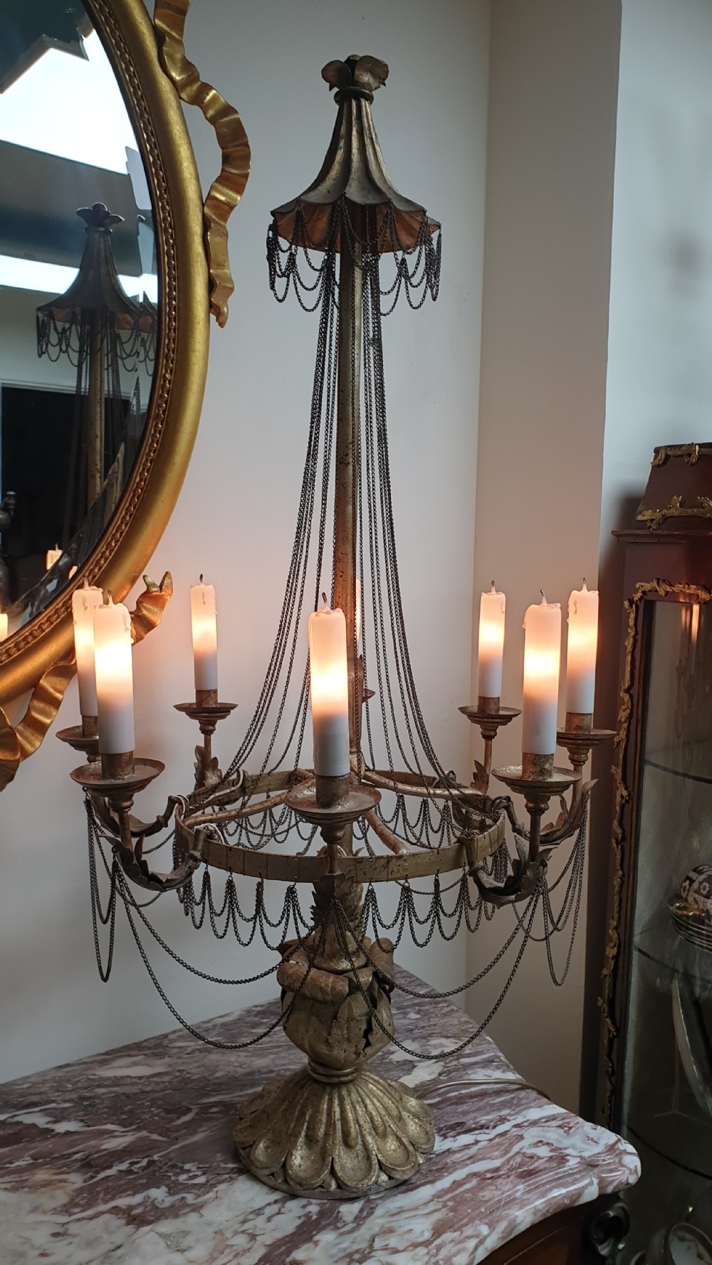 A pair of tall giltwood and metal eight-branch French candelabra table lamps featuring hanging wire swags and a tented canopy top. View IX
