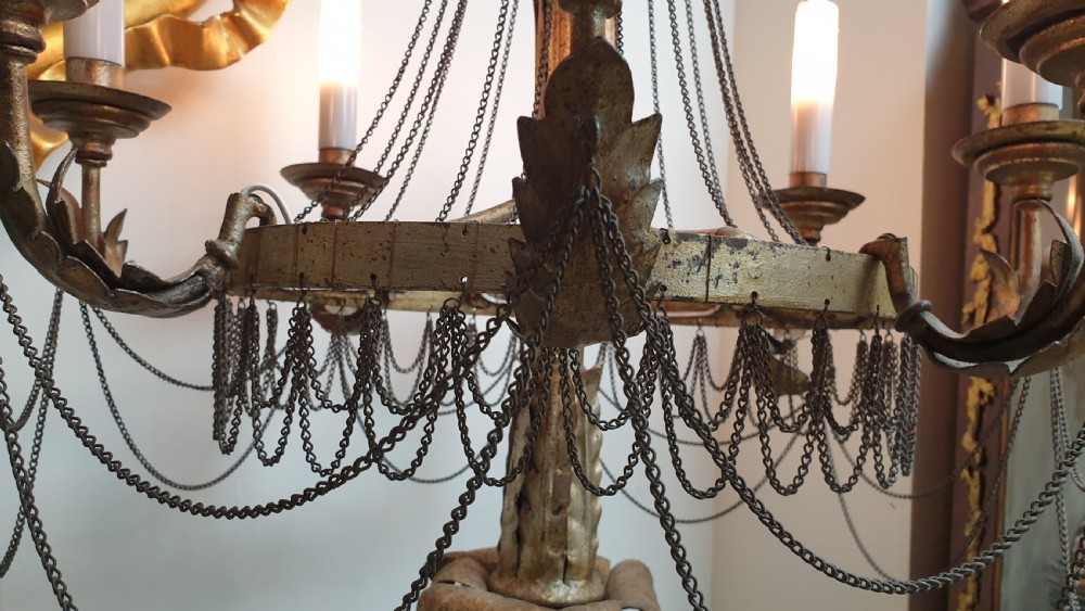 A pair of tall giltwood and metal eight-branch French candelabra table lamps featuring hanging wire swags and a tented canopy top. View X