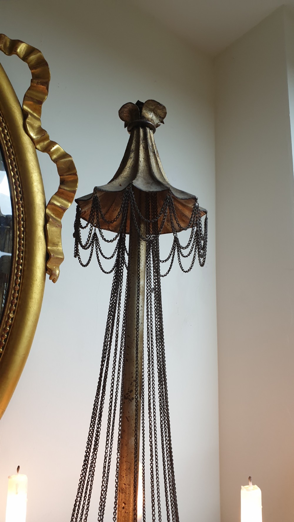 A pair of tall giltwood and metal eight-branch French candelabra table lamps featuring hanging wire swags and a tented canopy top. View XII