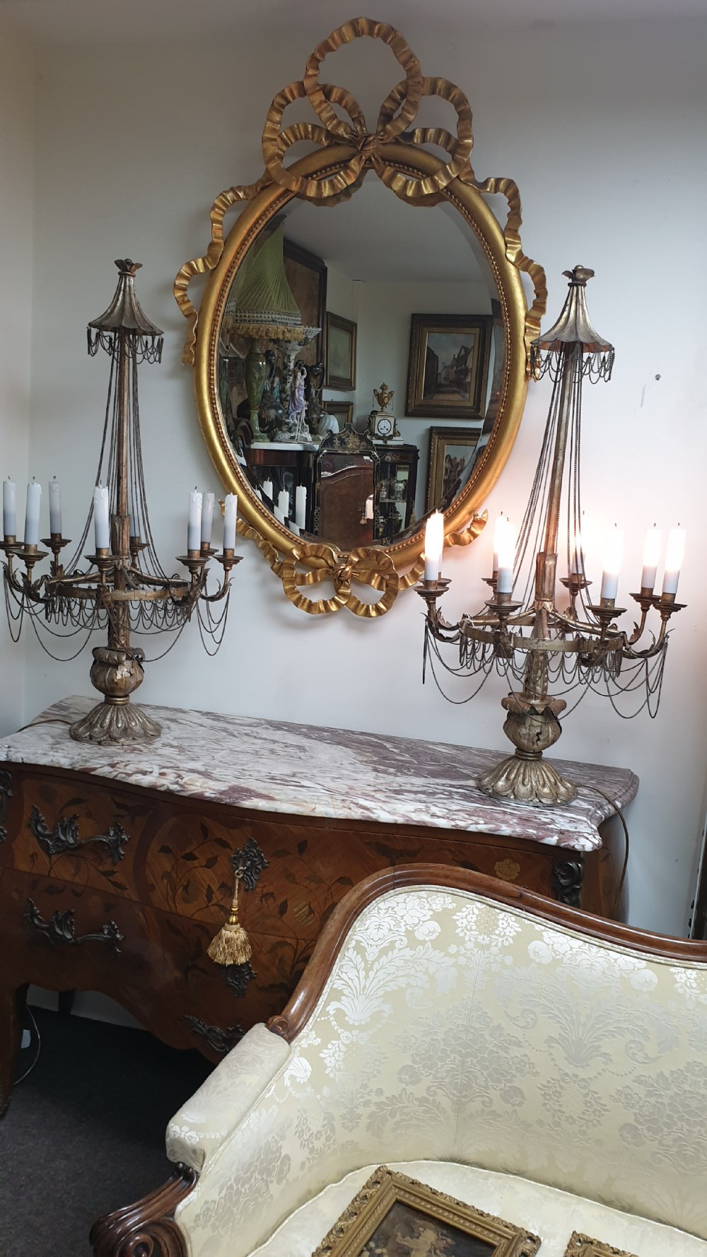 A pair of tall giltwood and metal eight-branch French candelabra table lamps featuring hanging wire swags and a tented canopy top. View XV