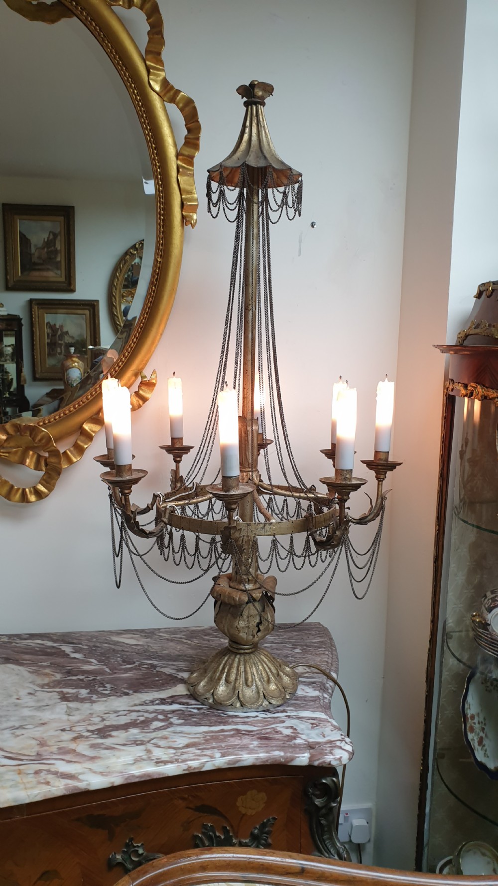 A pair of tall giltwood and metal eight-branch French candelabra table lamps featuring hanging wire swags and a tented canopy top. View XVII