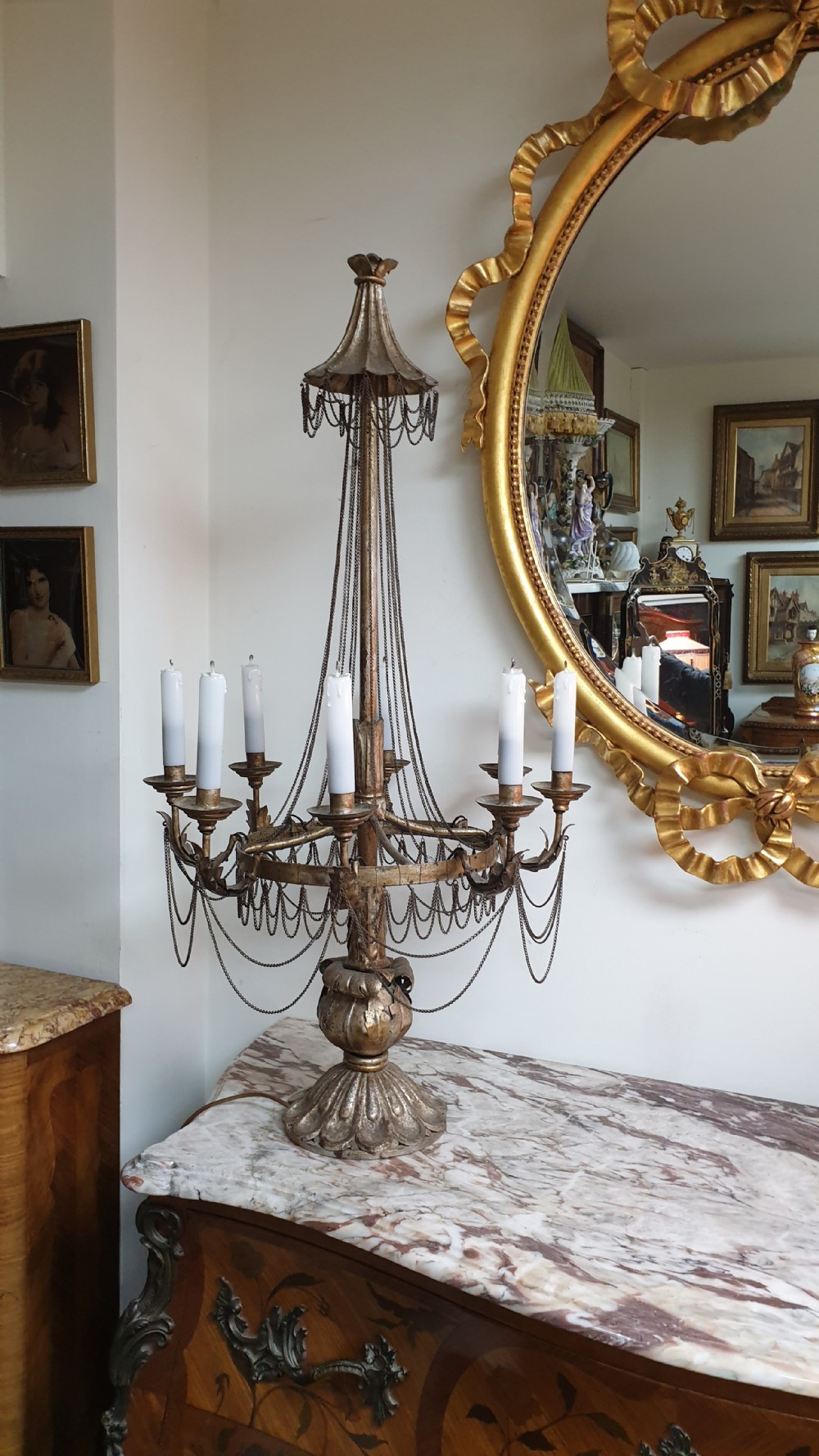 A pair of tall giltwood and metal eight-branch French candelabra table lamps featuring hanging wire swags and a tented canopy top. View XVIII