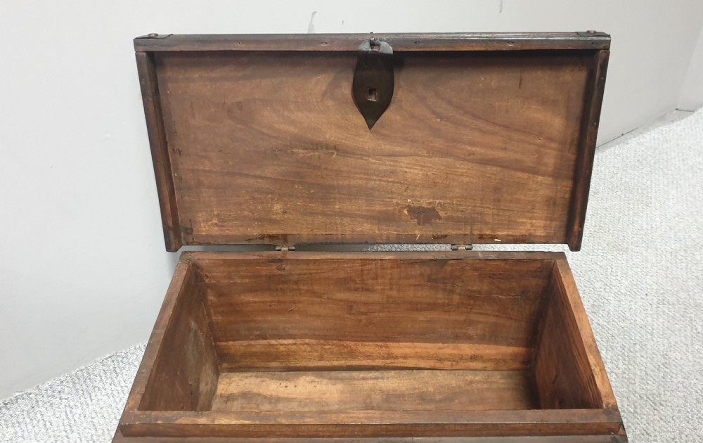 A dark mahogany wooden chest featuring decorative forged iron strapwork, corner brackets, and a central iron escutcheon plate. View IX