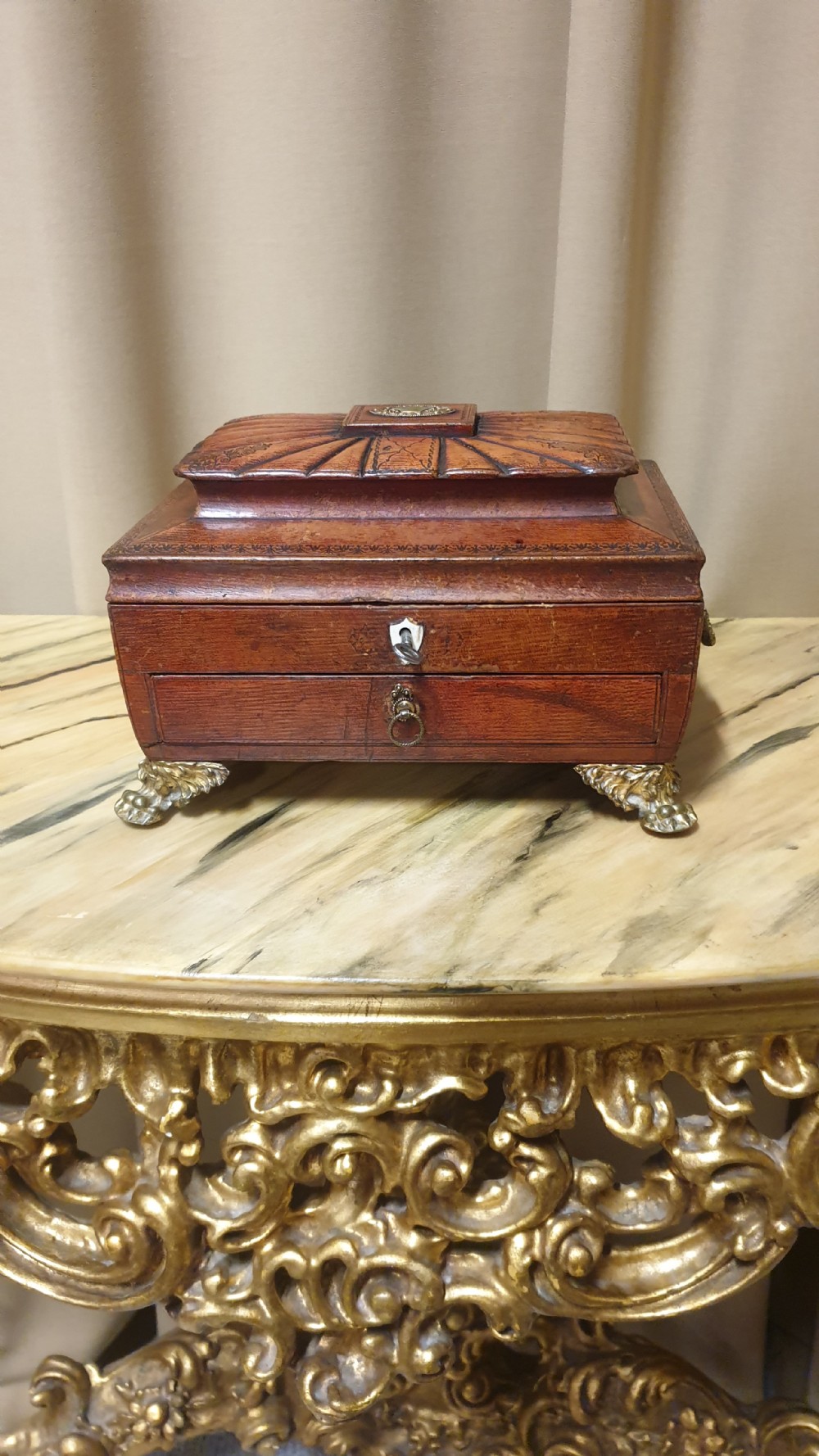A Regency period tooled brown leather sewing box featuring a sarcophagus-shaped lid, cast brass claw feet, side ring handles, and a lower drawer. View II