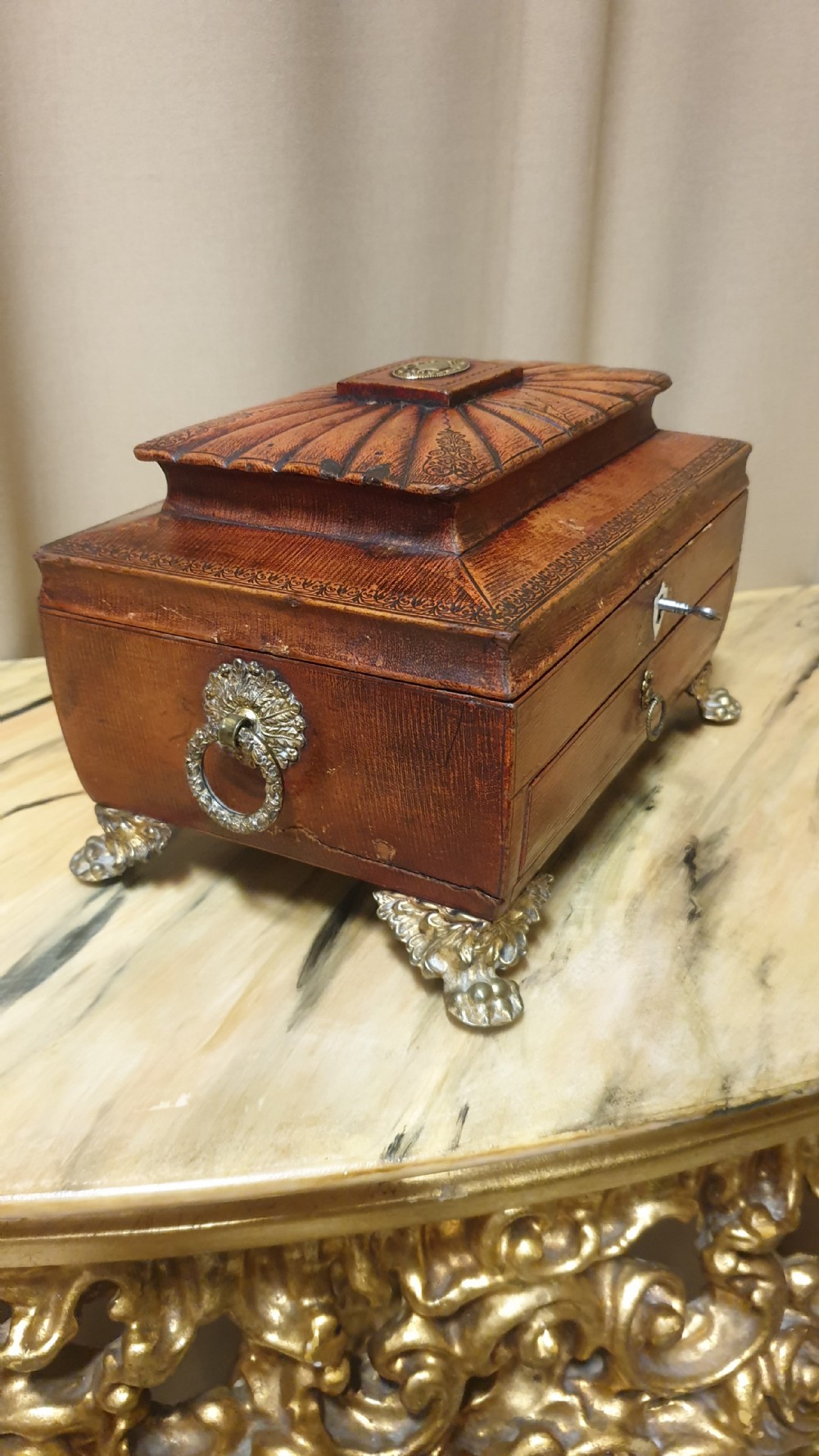 A Regency period tooled brown leather sewing box featuring a sarcophagus-shaped lid, cast brass claw feet, side ring handles, and a lower drawer. View IX