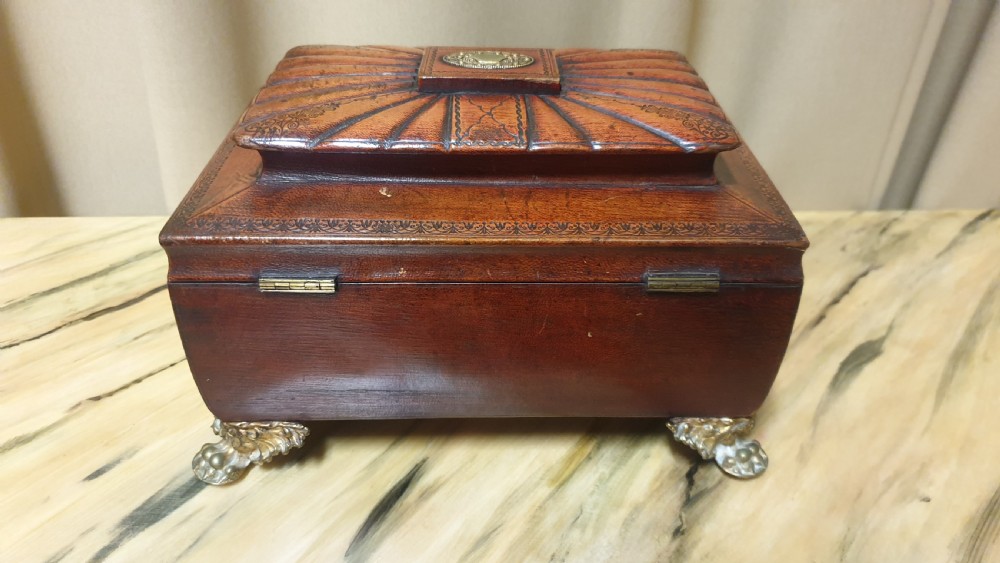 A Regency period tooled brown leather sewing box featuring a sarcophagus-shaped lid, cast brass claw feet, side ring handles, and a lower drawer. View XI
