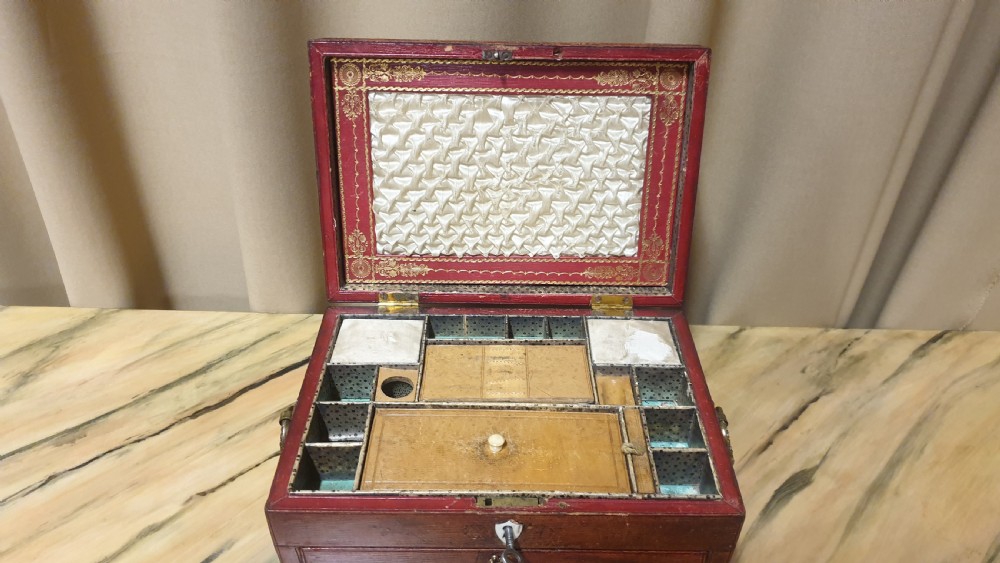A Regency period tooled brown leather sewing box featuring a sarcophagus-shaped lid, cast brass claw feet, side ring handles, and a lower drawer. View XII
