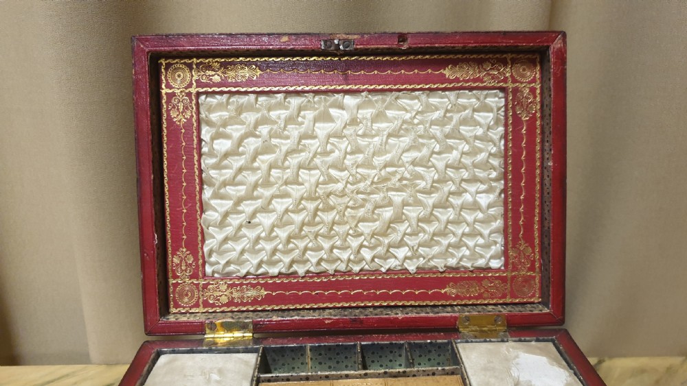 A Regency period tooled brown leather sewing box featuring a sarcophagus-shaped lid, cast brass claw feet, side ring handles, and a lower drawer. View XIV
