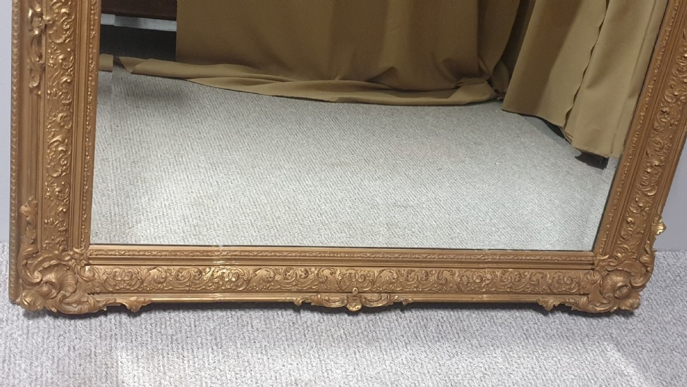 A large rectangular Victorian gilt wall mirror featuring an ornate frame embellished with acanthus leaf and scrollwork mouldings. View III