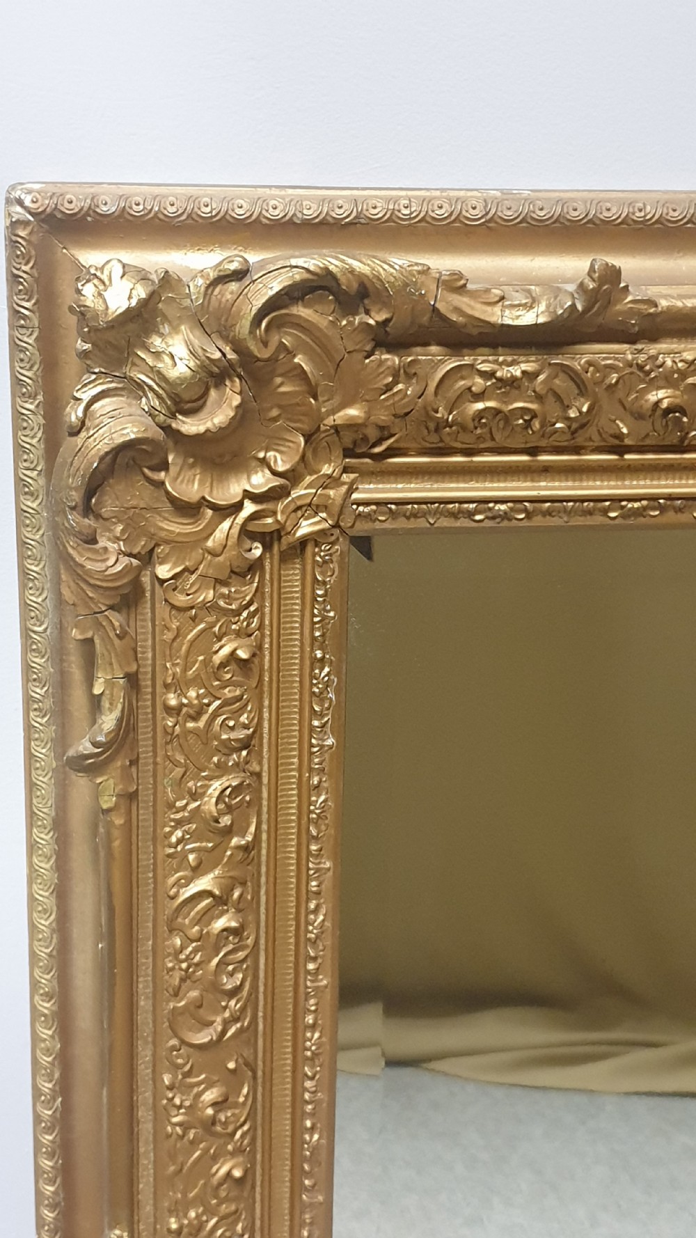A large rectangular Victorian gilt wall mirror featuring an ornate frame embellished with acanthus leaf and scrollwork mouldings. View IV