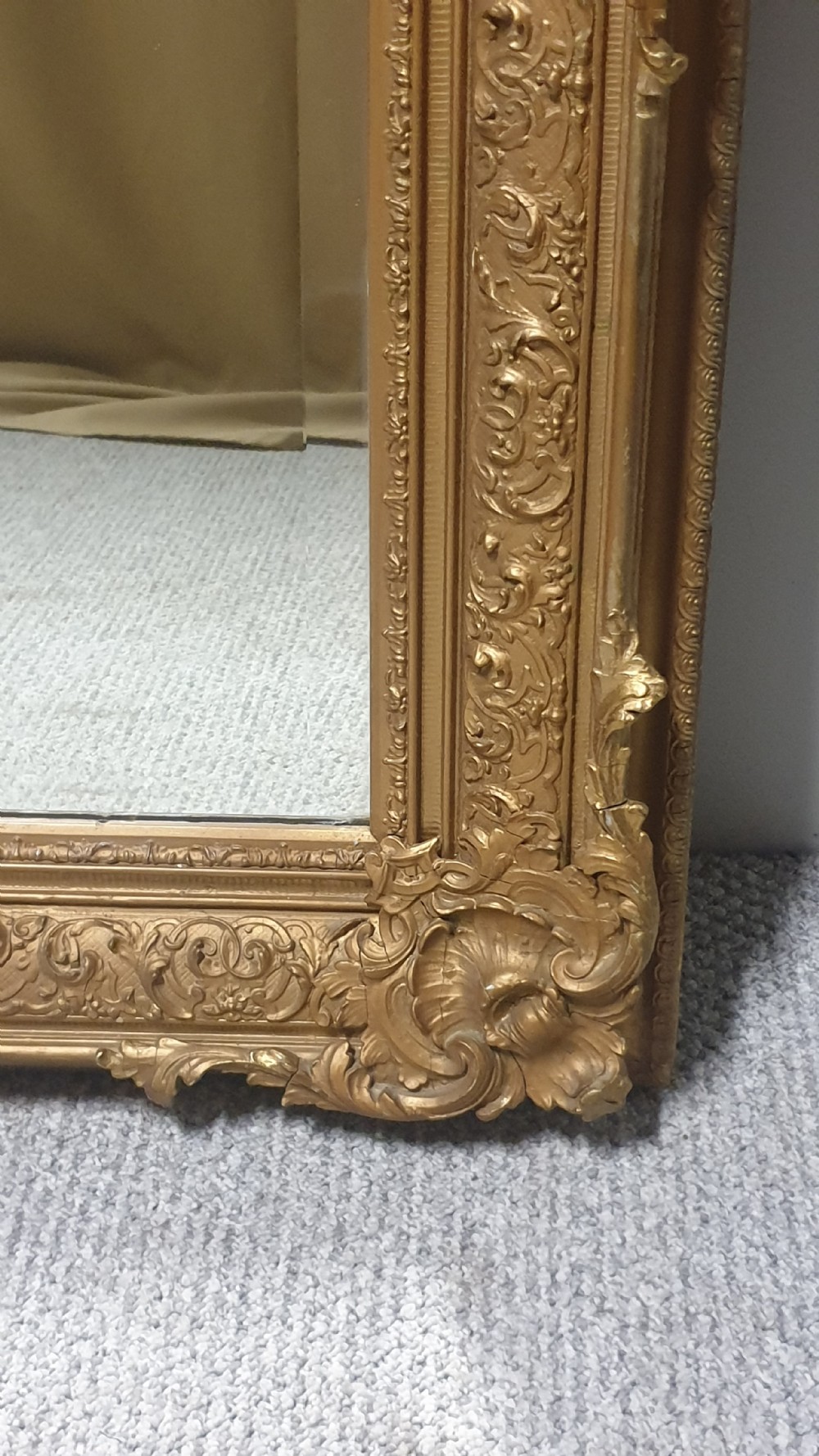 A large rectangular Victorian gilt wall mirror featuring an ornate frame embellished with acanthus leaf and scrollwork mouldings. View V