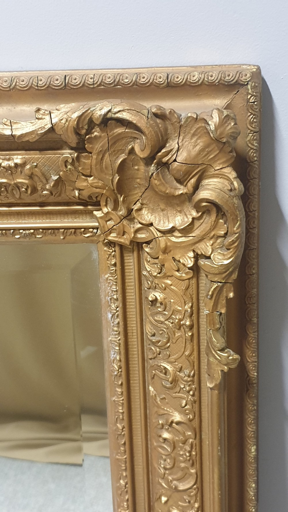 A large rectangular Victorian gilt wall mirror featuring an ornate frame embellished with acanthus leaf and scrollwork mouldings. View VI