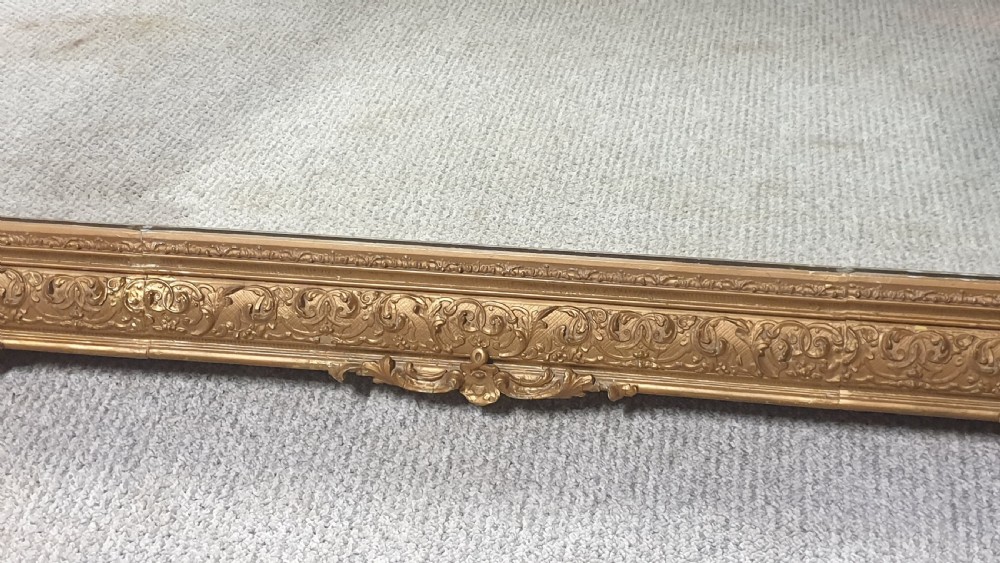A large rectangular Victorian gilt wall mirror featuring an ornate frame embellished with acanthus leaf and scrollwork mouldings. View VII