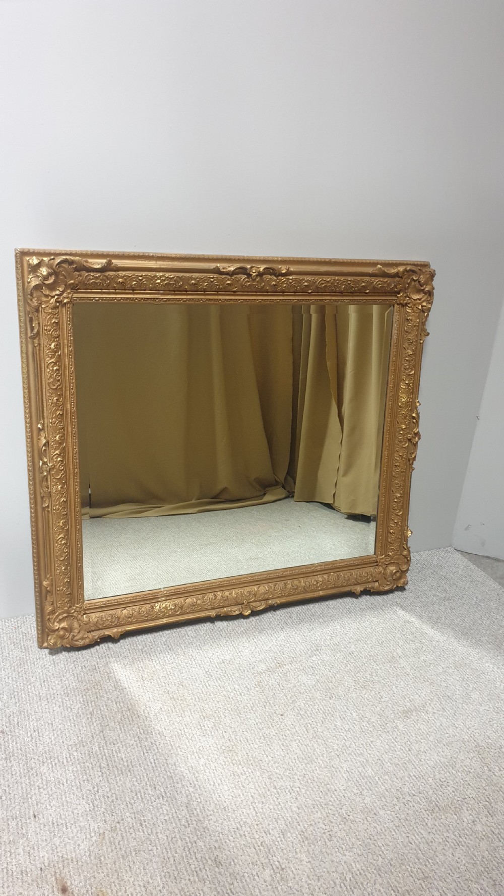 A large rectangular Victorian gilt wall mirror featuring an ornate frame embellished with acanthus leaf and scrollwork mouldings. View X