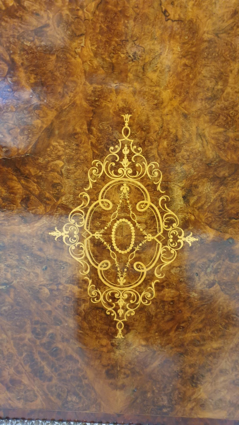 A Victorian burr walnut credenza featuring a central inlaid cupboard door flanked by two curved glazed display side cabinets and decorative gilt ormolu mounts. View III